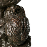 Close-up of baby owl in handcrafted bronze family sculpture with detailed plumage
