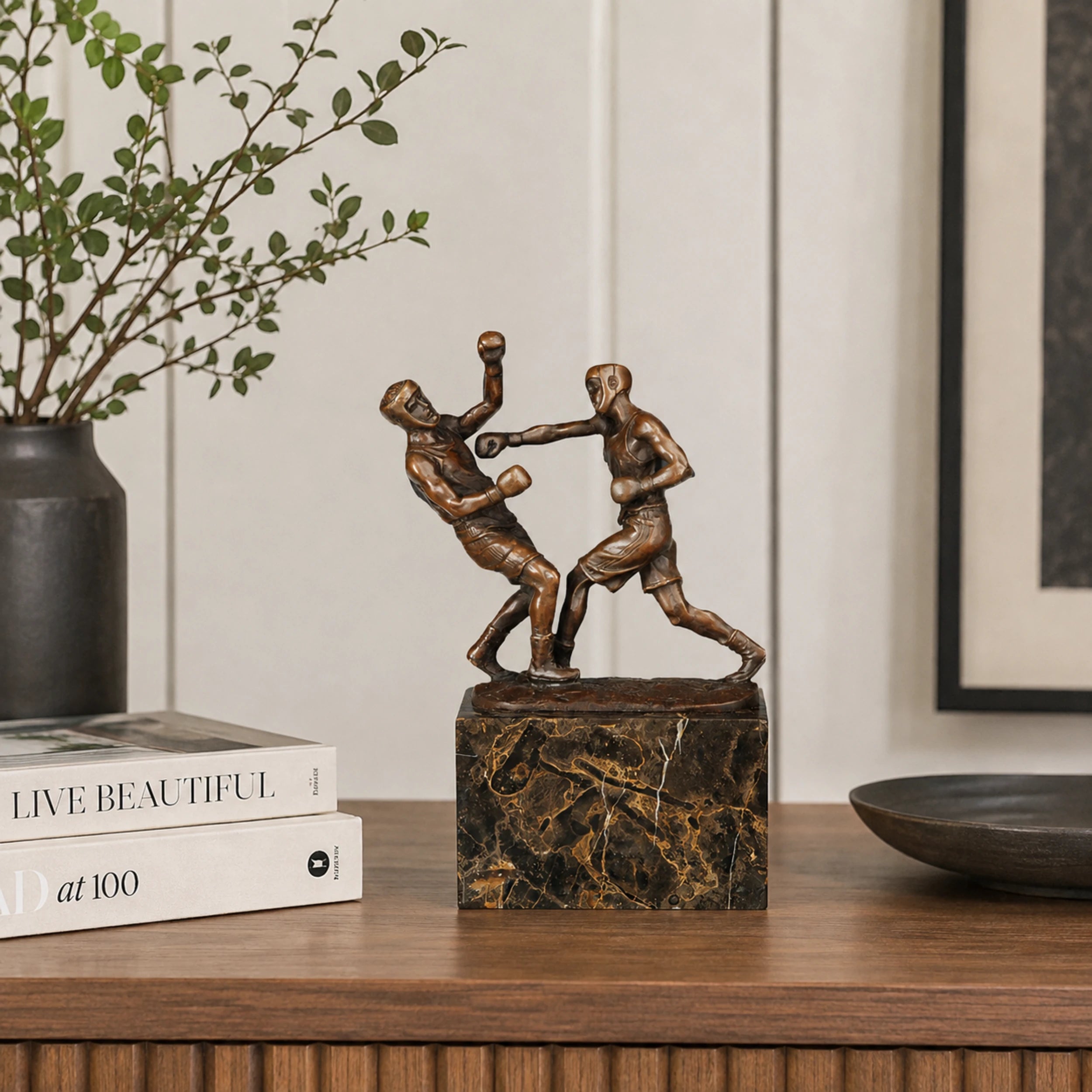 Bronze boxing fighters sculpture displayed as sports decor in a modern gym or boxing club
