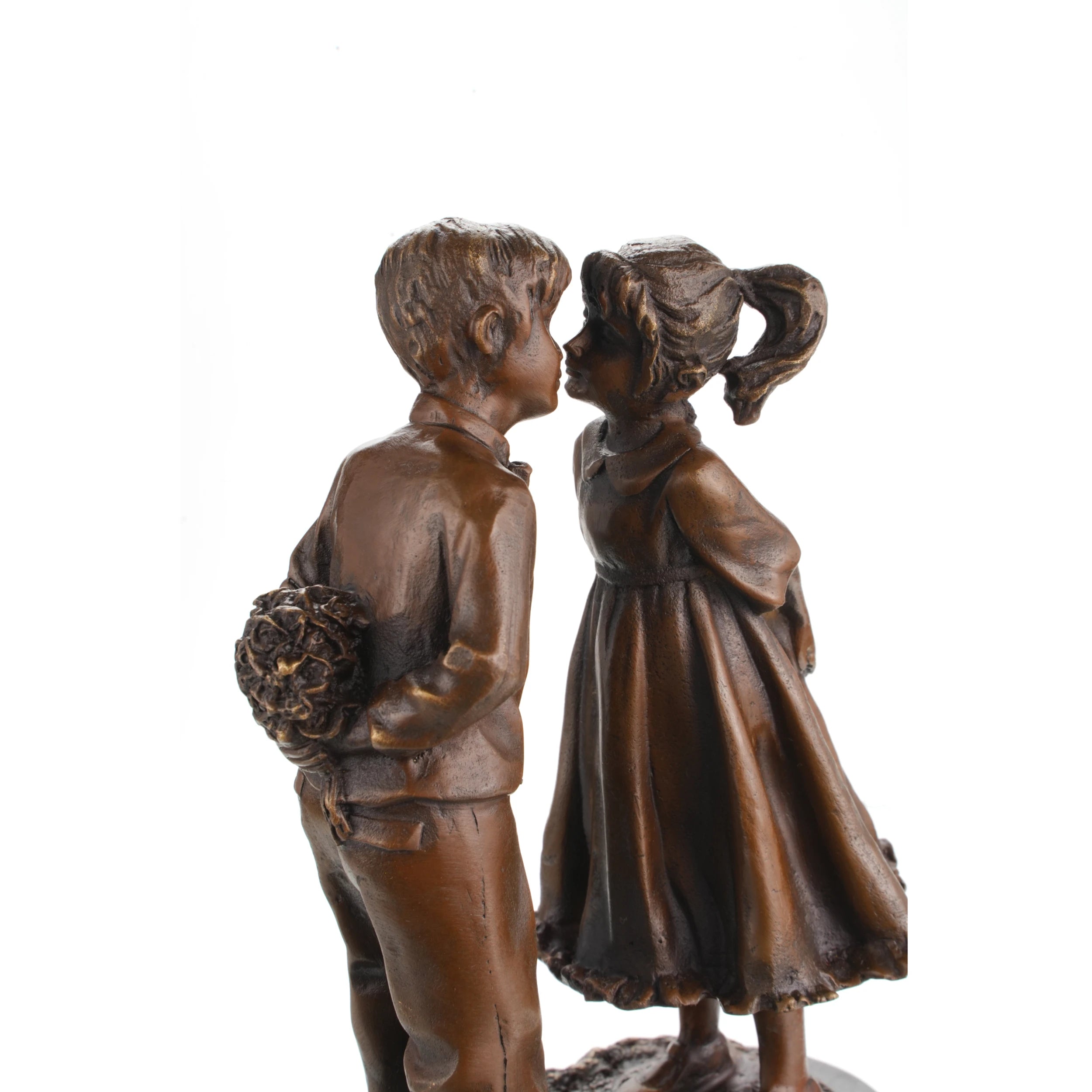 Close-up detail of a bronze boy and girl sculpture showing expressive faces and hand-finished bronze patina.