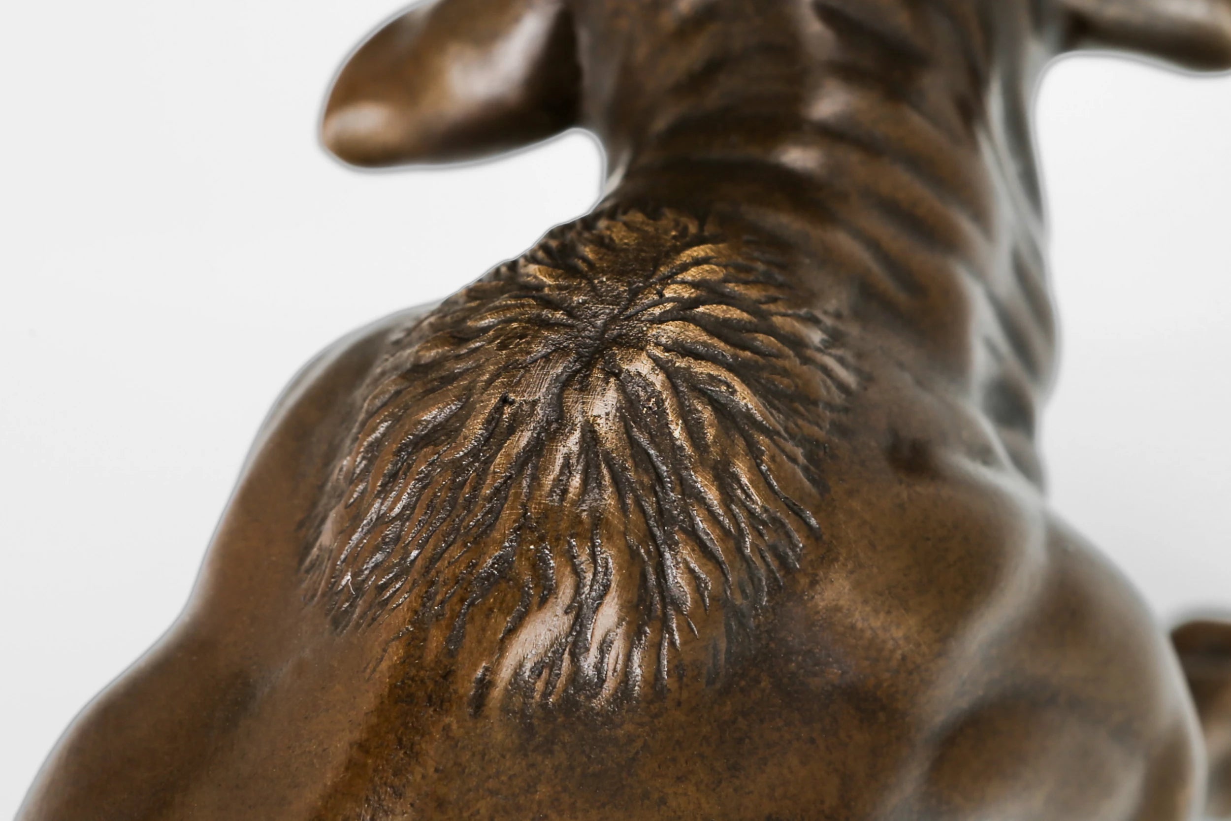 Detailed view of the handcrafted bronze bull sculpture highlighting realistic musculature and warm bronze patina.
