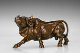 Side profile of a handcrafted bronze bull sculpture with realistic muscular details.