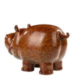 Hand-applied bronze patina on cartoon cow sculpture