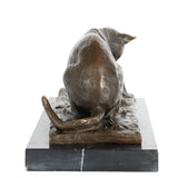 rear view of bronze cat and butterfly sculpture showing crouching pose and textured fur
