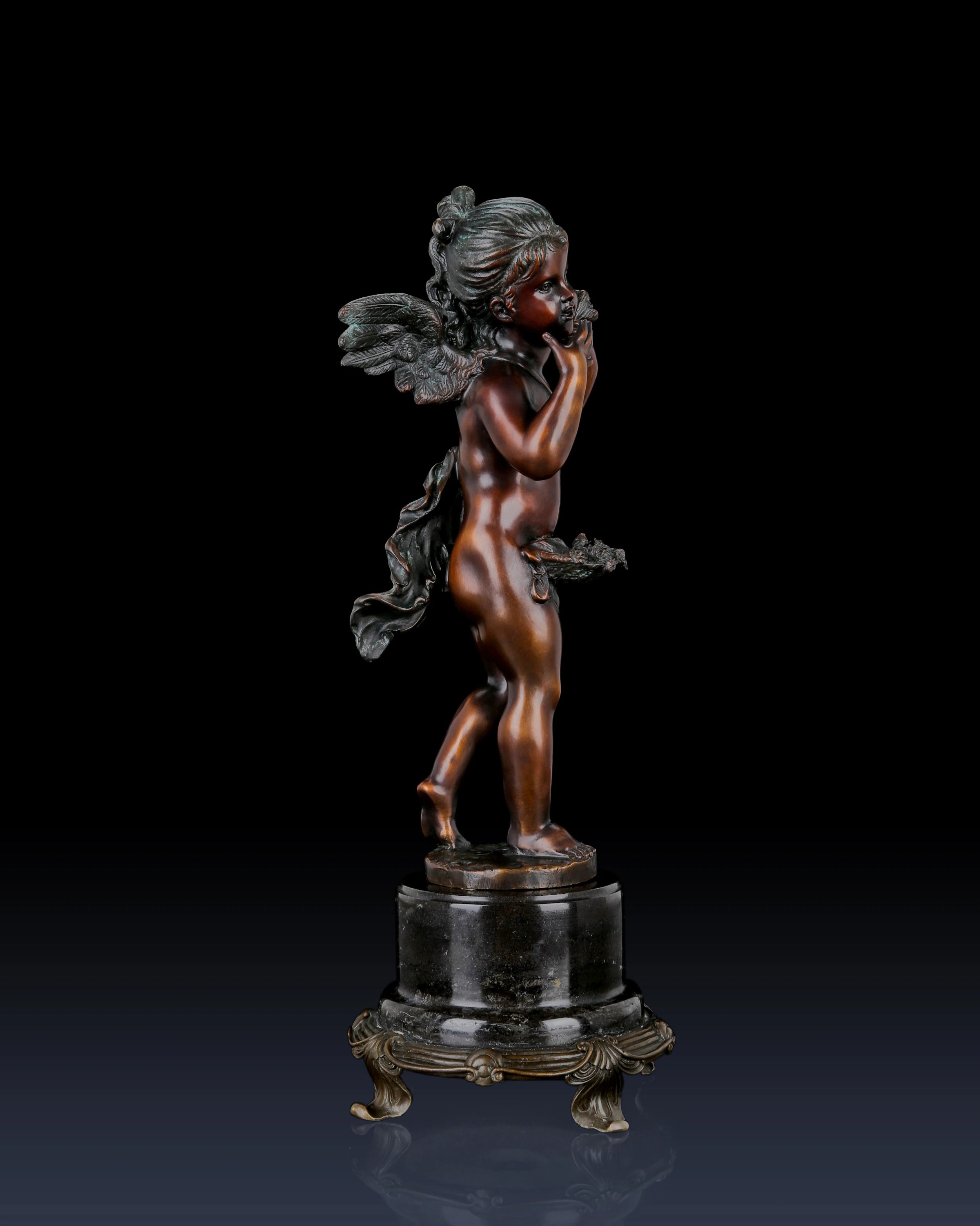 Handcrafted bronze Putto sculpture with classical cherub styling and ornate marble base. Lost-wax cast decorative figure for elegant home décor, galleries, and fine art collections.