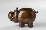 Left side view of a cute bronze cow
 sculpture for shelf and desk decor.