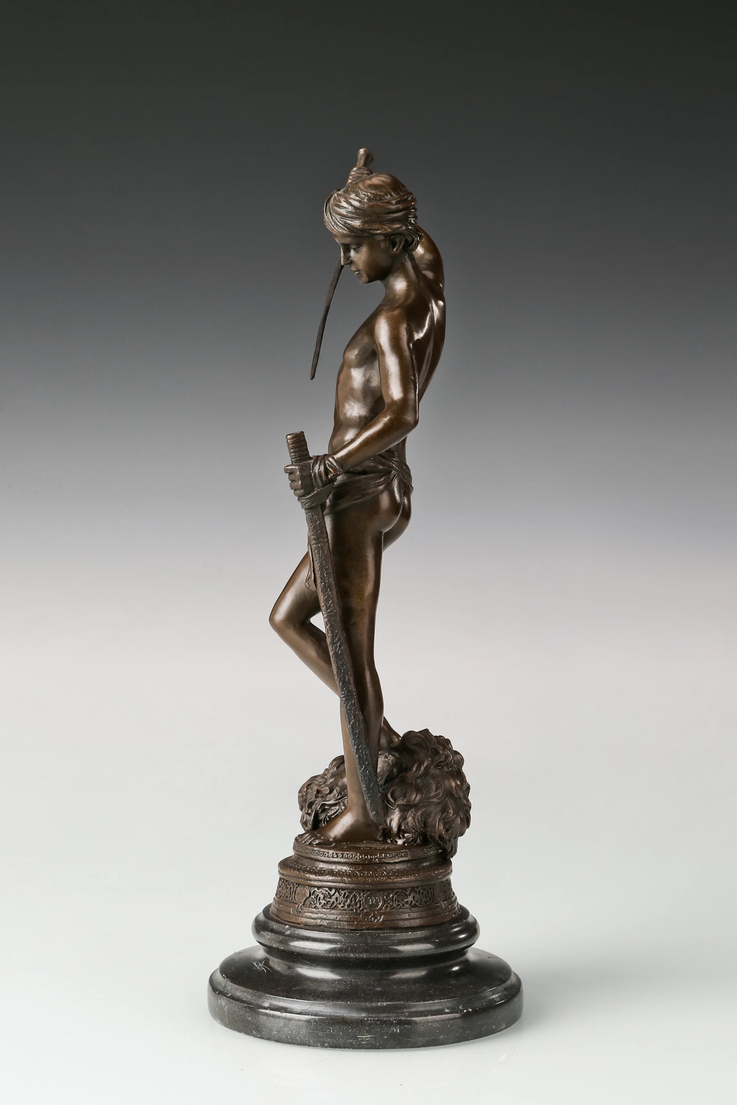 Left side view of bronze biblical David sculpture with sword