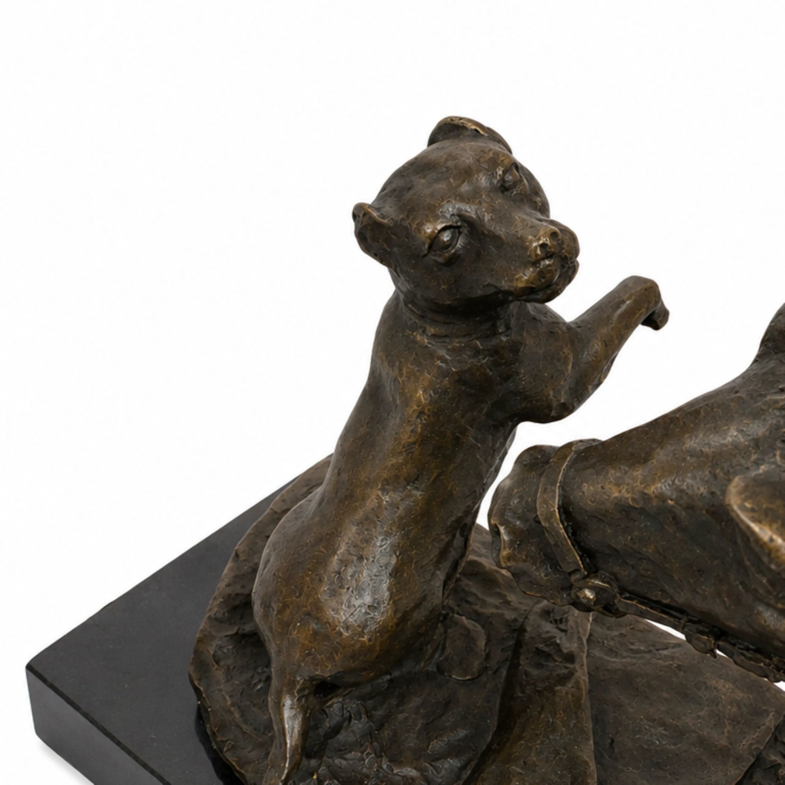 Close-up of small bronze dog interacting with the horse in an animal friendship sculpture