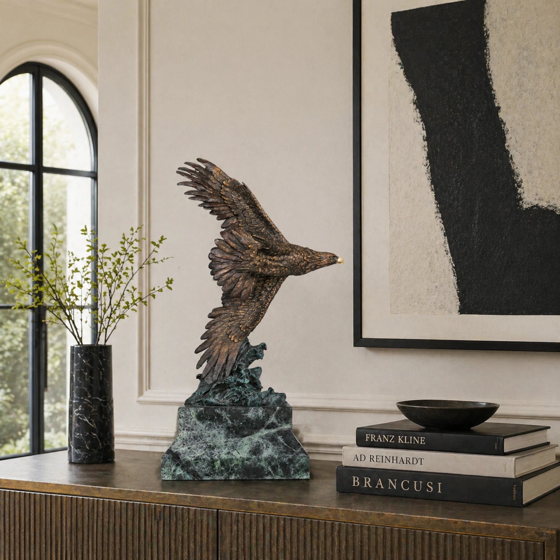 Bronze eagle sculpture with wings spread, capturing a powerful takeoff moment. A bold statue symbolizing strength, freedom, and ambition.