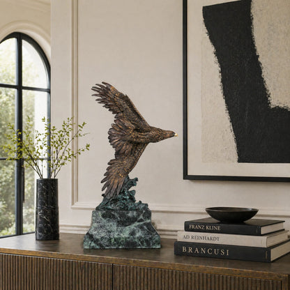 Bronze eagle sculpture with wings spread, capturing a powerful takeoff moment. A bold statue symbolizing strength, freedom, and ambition.