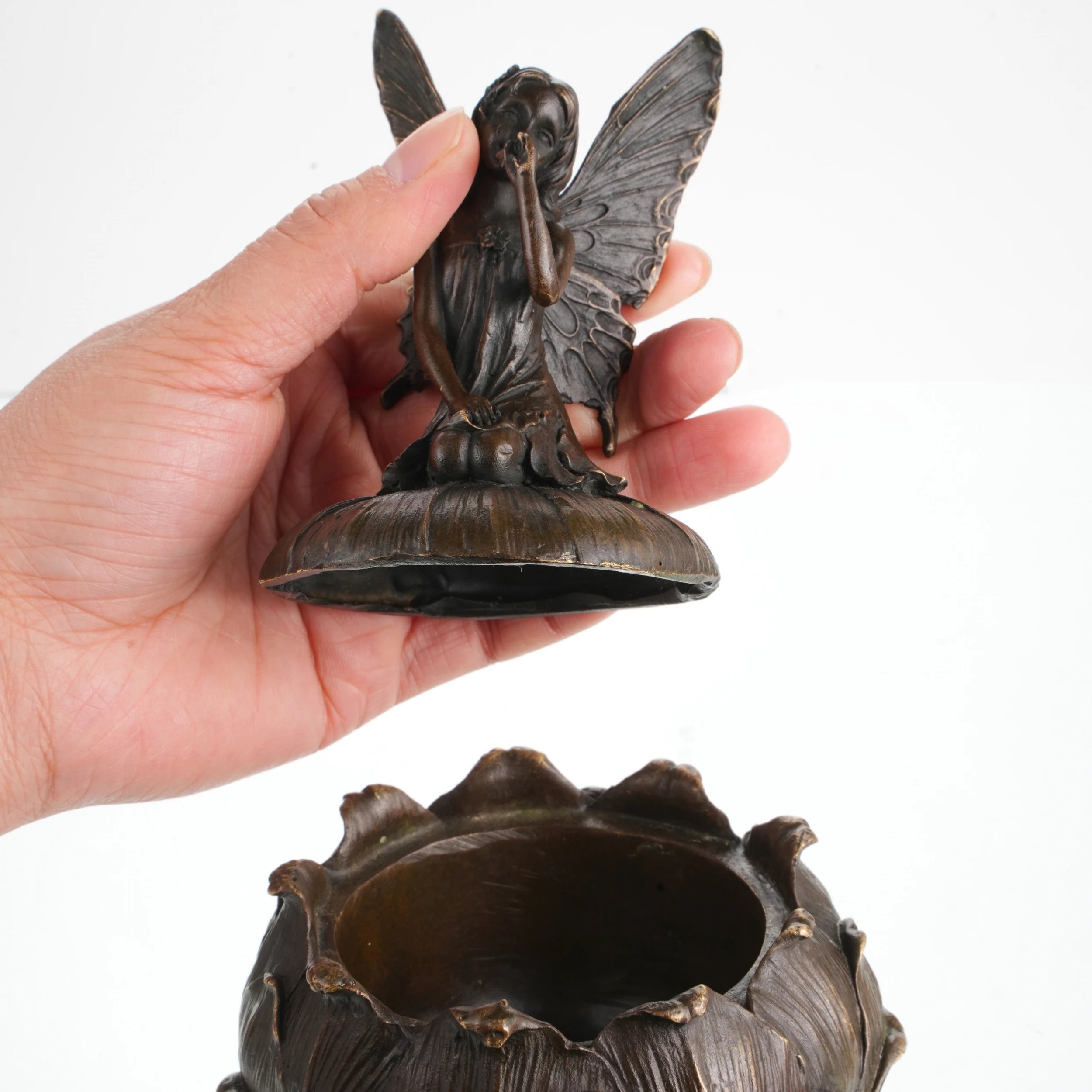 Bronze fairy jewelry box opened to reveal hidden storage compartment for jewelry and keepsakes