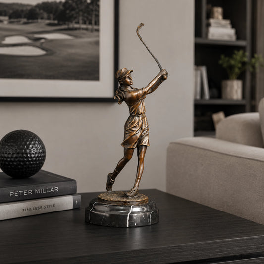 Handcrafted bronze female golfer sculpture captured in an elegant follow-through golf swing
