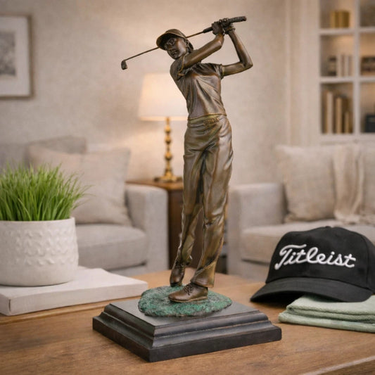Handcrafted bronze female golfer swing sculpture displayed in a modern office interior.