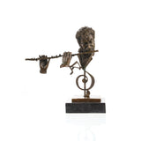 Front view of a handcrafted bronze flutist sculpture with musical note on a marble base.
