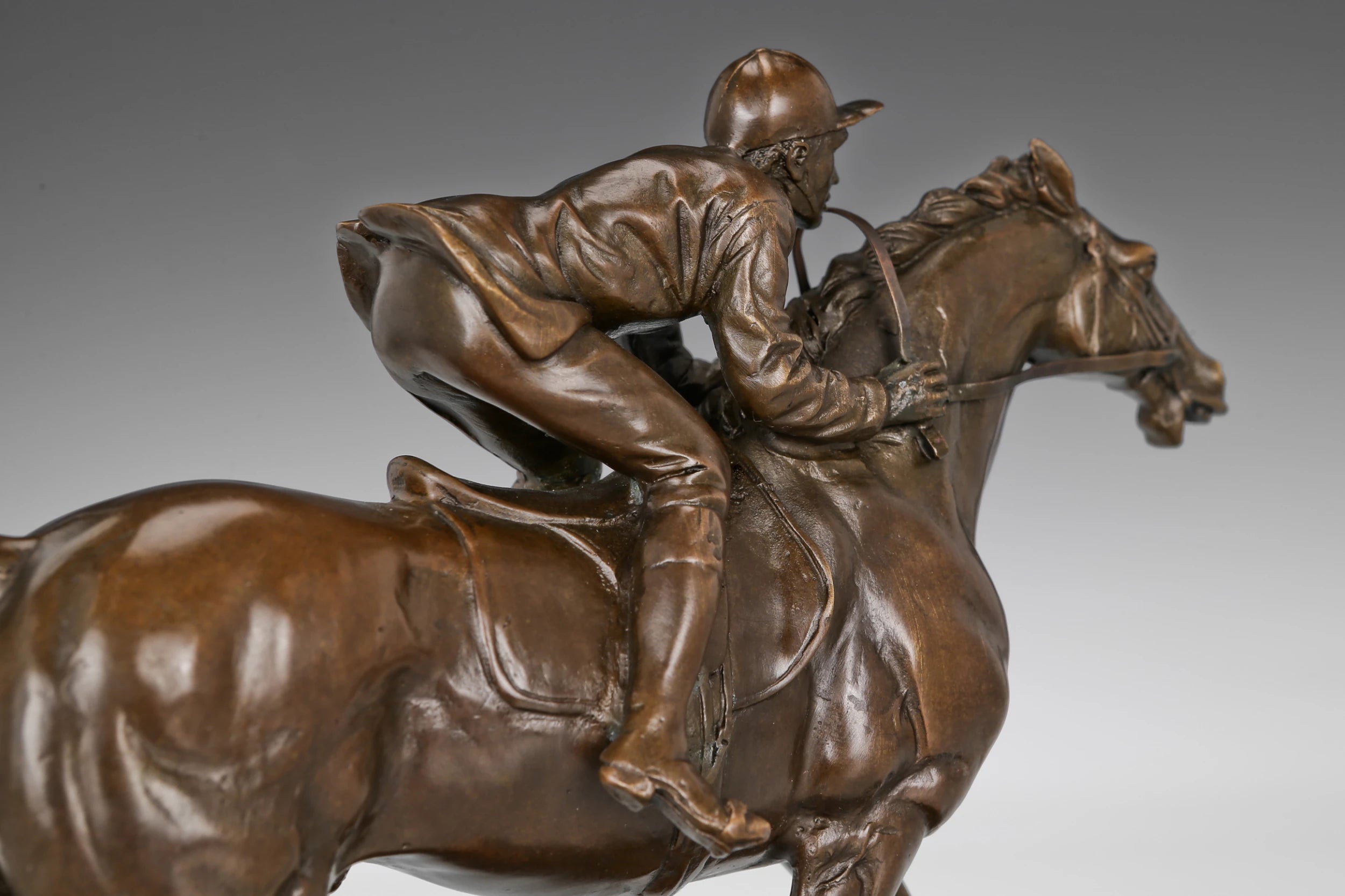 Close-up of bronze galloping racehorse showing muscular movement and sculpted athletic form