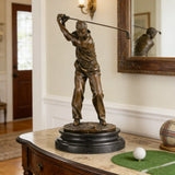 Bronze golfer swing sculpture displayed in an executive office or golf-themed interior.