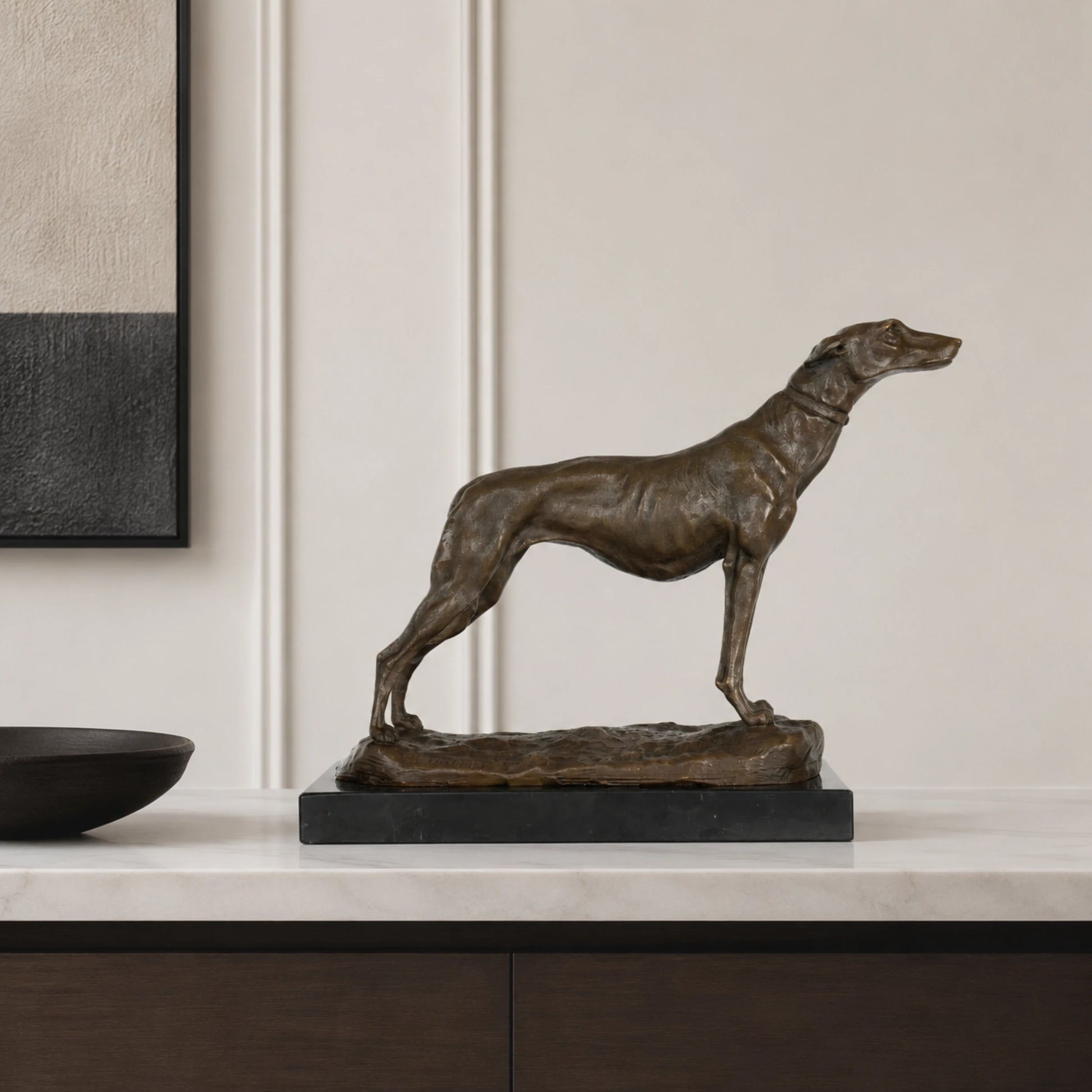 An elegant bronze greyhound sculpture in an alert stance, crafted using the lost-wax casting method with a rich warm patina for home library or office decor.