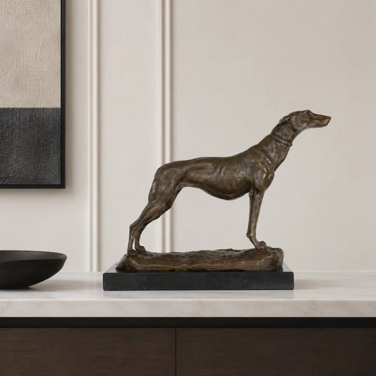 An elegant bronze greyhound sculpture in an alert stance, crafted using the lost-wax casting method with a rich warm patina for home library or office decor.