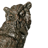 Close-up of bronze horned owl sculpture showing expressive eyes beak and raised ear tufts