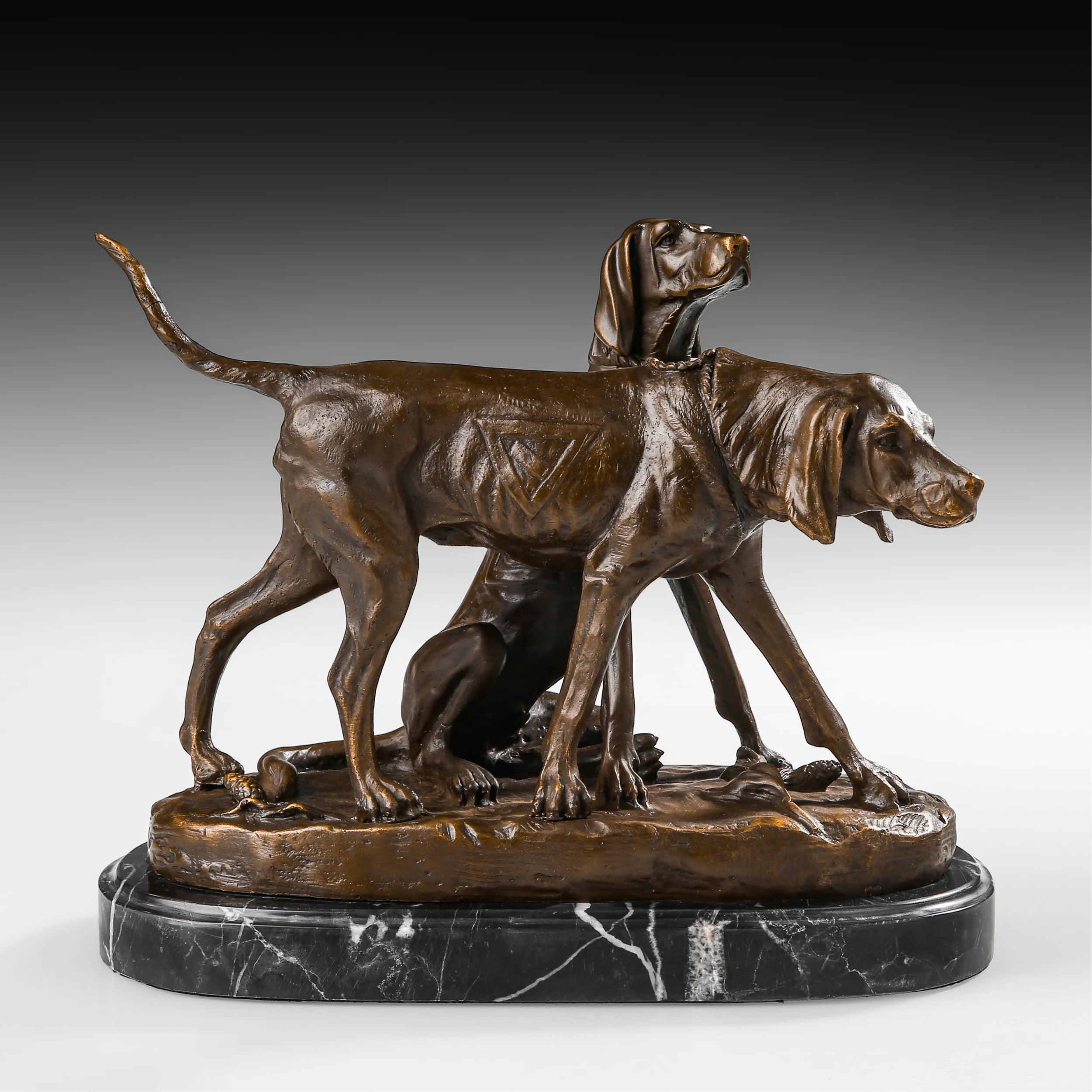 Handcrafted bronze hunting dog pair sculpture with one standing dog and one seated sporting dog