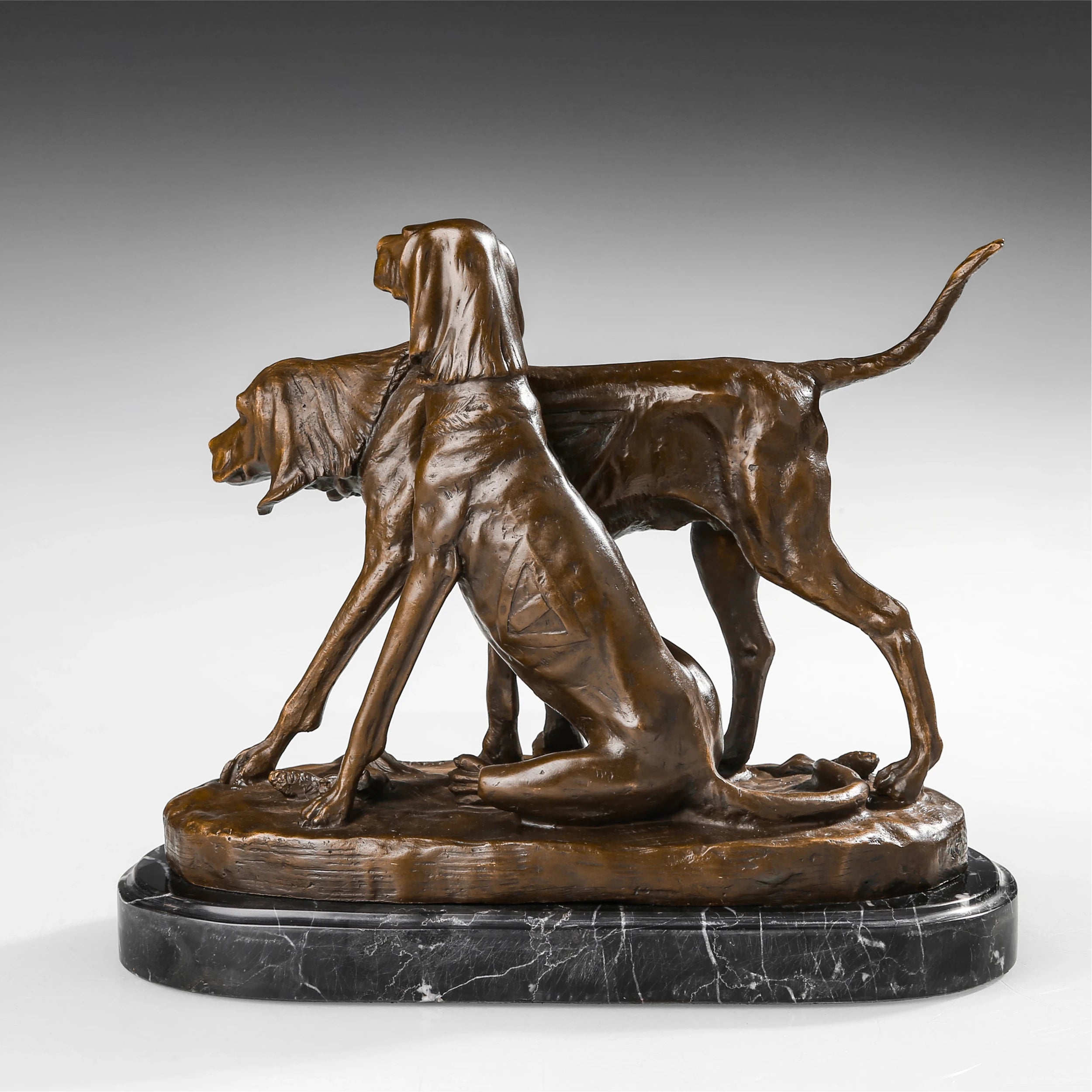 Left side view of bronze hunting dog group sculpture with detailed ears collars and body forms