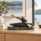 Abstract bronze kayaker statue with paddle displayed as modern water sports and office decor