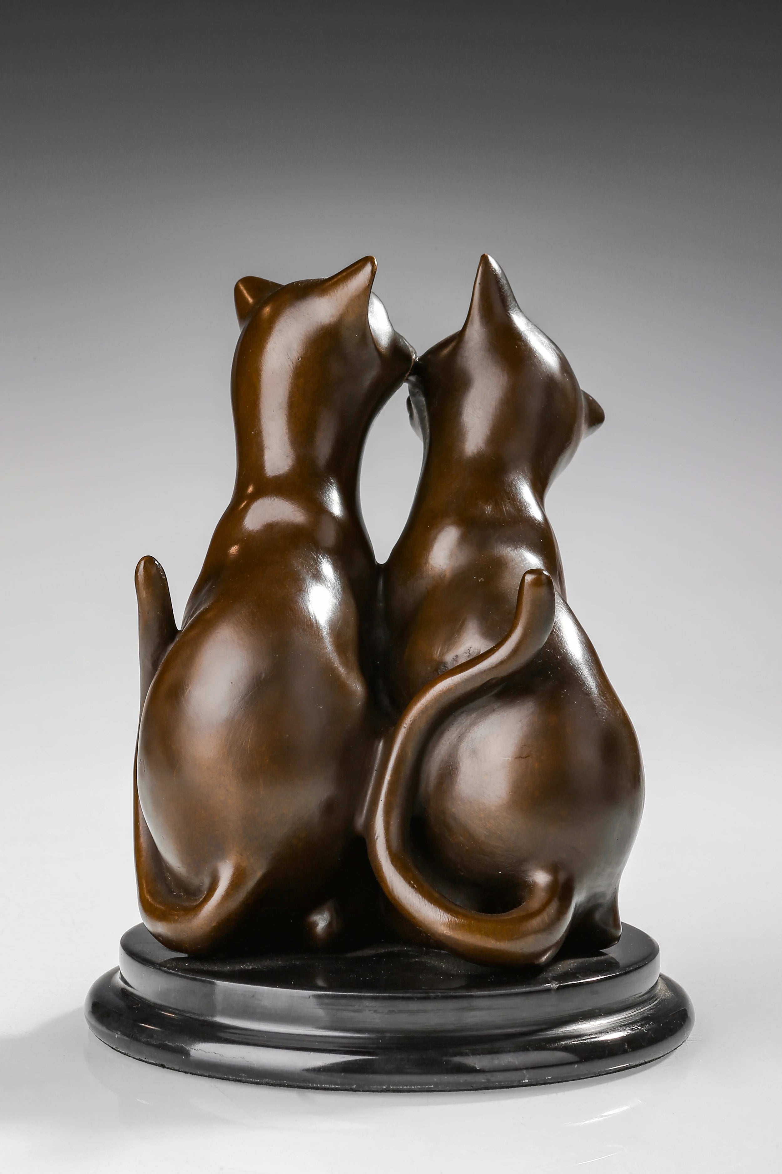 rearview of handcrafted bronze kissing cats statue with warm hand-applied patina