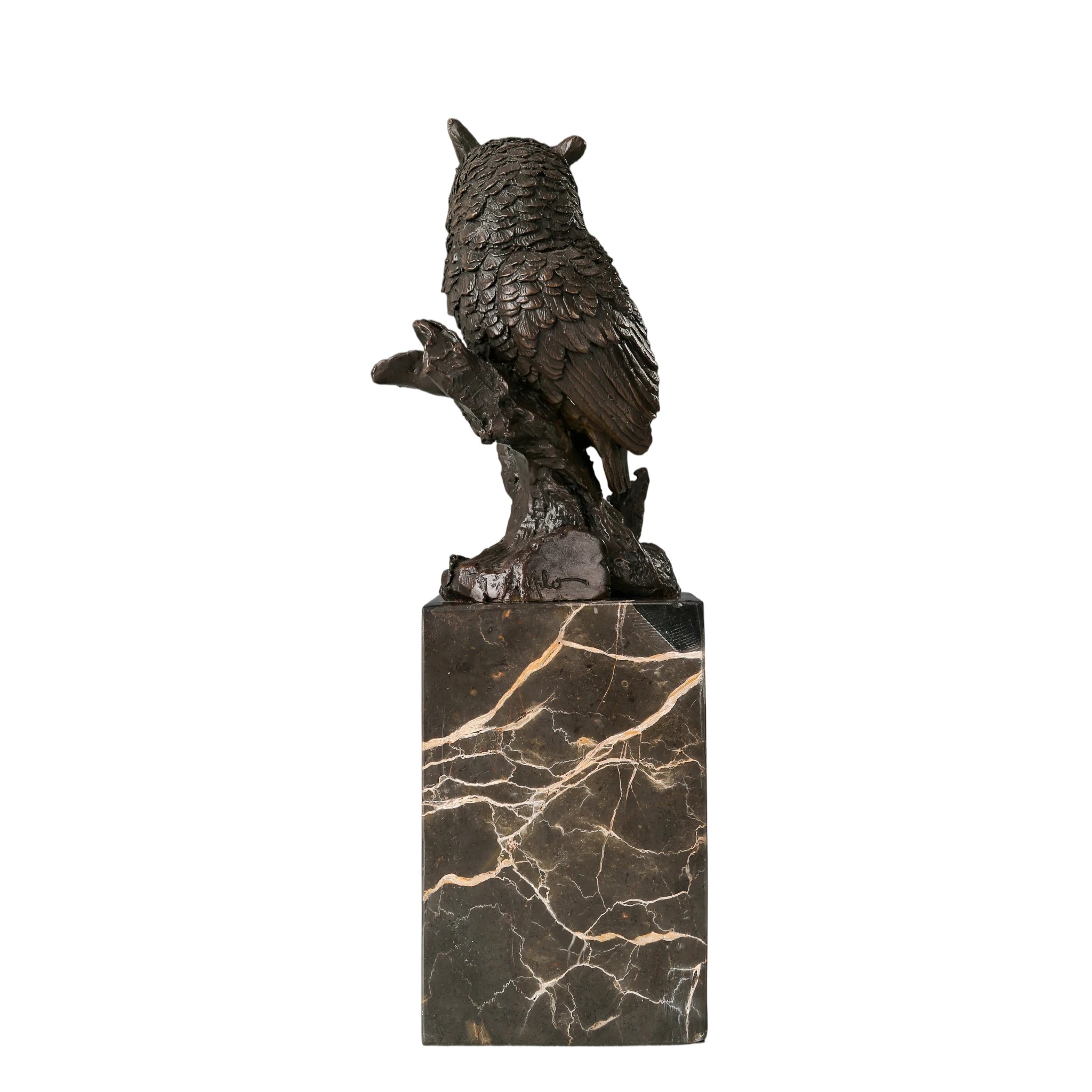 Rear view of realistic bronze owl sculpture showing layered wing and feather details