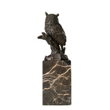 Rear view of realistic bronze owl sculpture showing layered wing and feather details