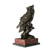 Handcrafted bronze owl on branch sculpture with detailed feathers and alert horned profile