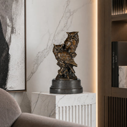 Realistic bronze sculpture featuring two owls perched on a tree stump with detailed feather textures. A refined wildlife artwork for collectors and nature lovers.