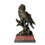 Rear view of bronze owl sculpture showing layered tail and wing feather details