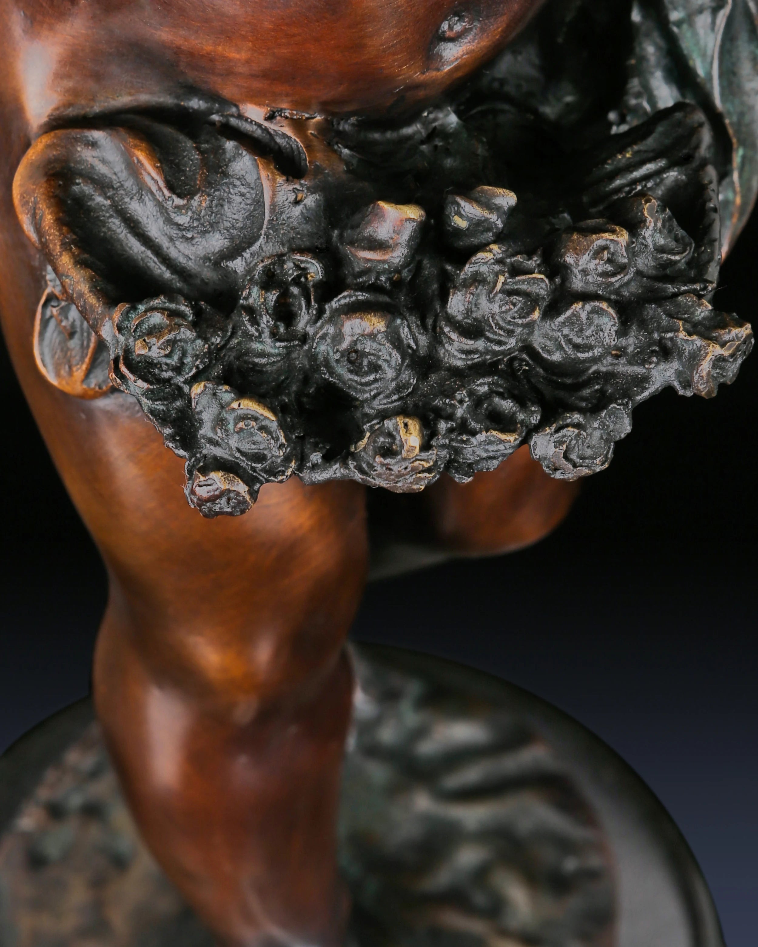 Ornate natural marble base supporting a handcrafted classical bronze Putto statue