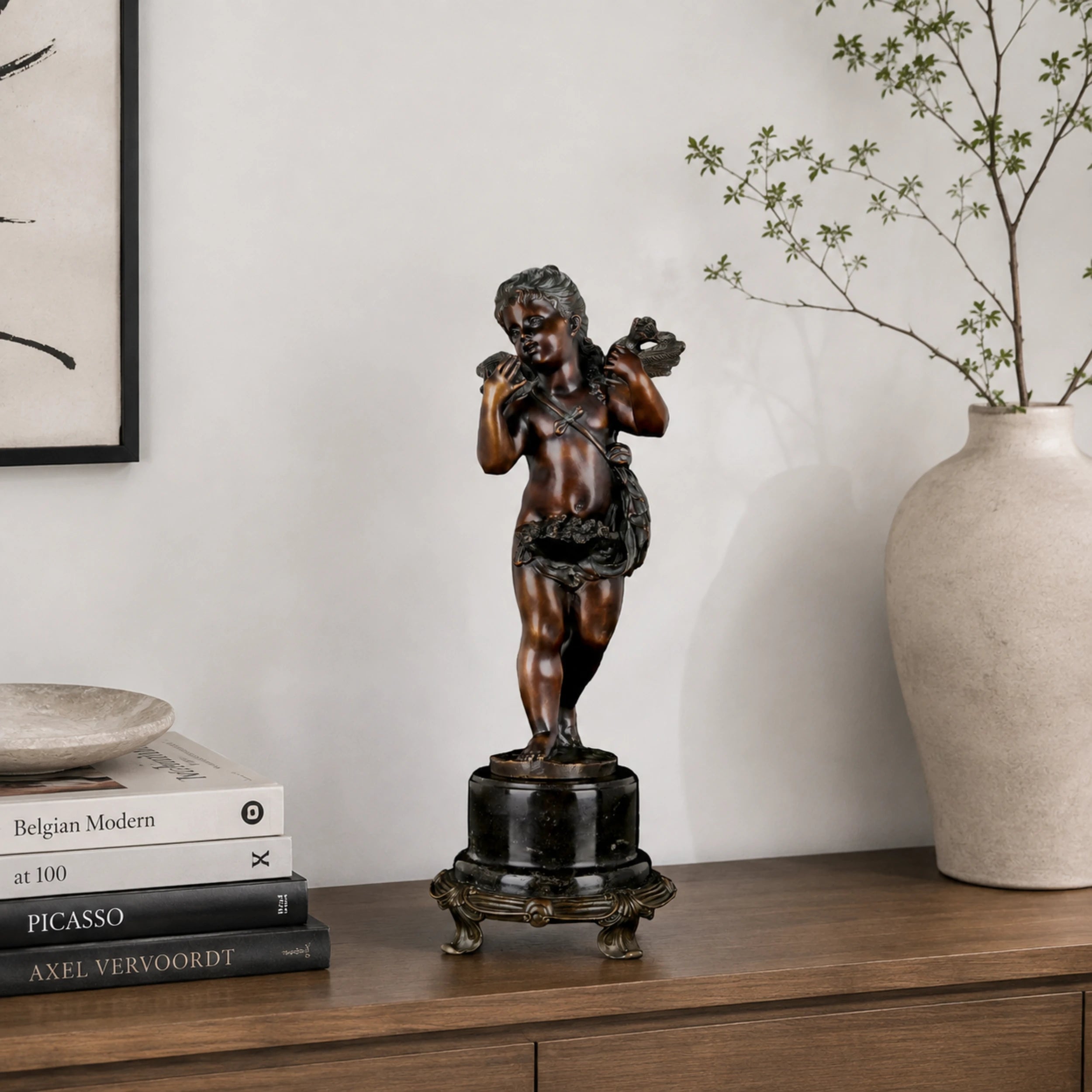 Classical bronze Putto sculpture displayed as elegant luxury home décor in a refined interior