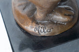 Close-up of base detail on a handcrafted bronze rabbit sculpture
