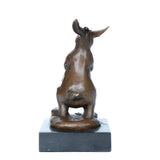 Rearview of bronze rabbit statue holding a basket filled with flowers