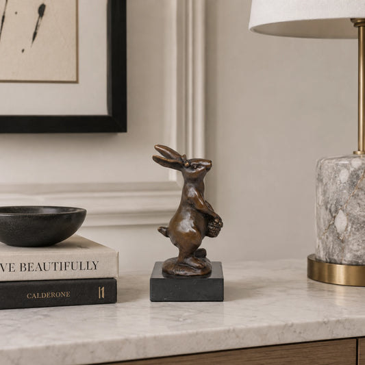 Bronze rabbit with flower basket displayed as charming spring and home decor