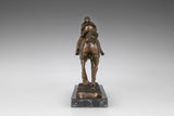 Rear view of bronze racehorse and jockey sculpture showing flowing tail and racing posture