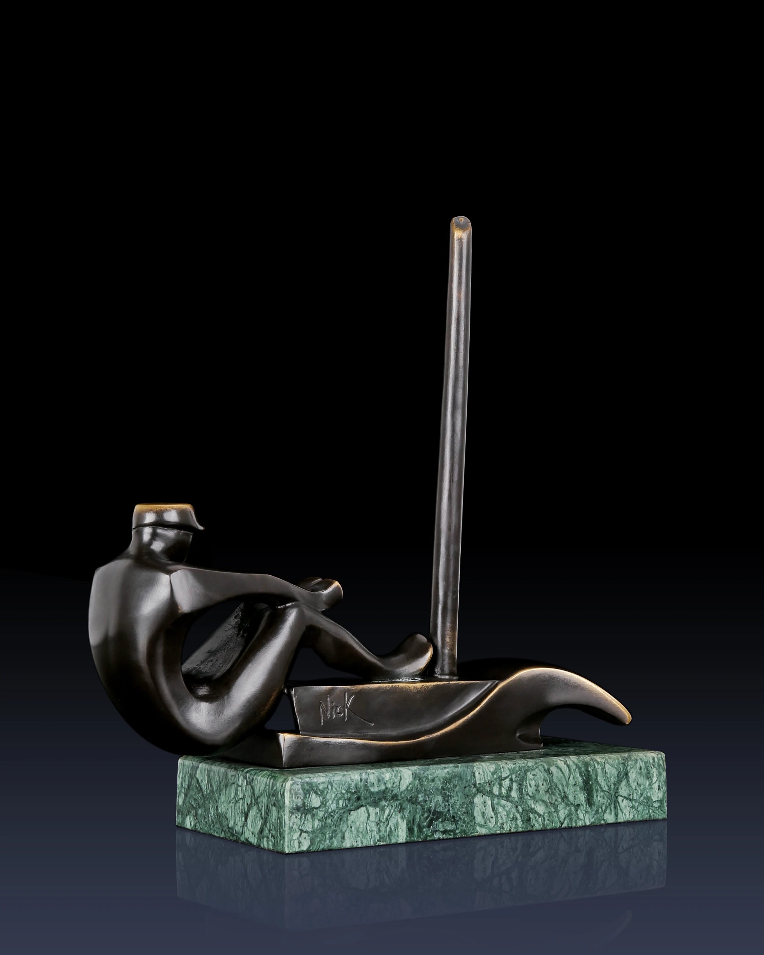 Left side view of bronze sailing sculpture with stylized sailor and contemporary boat design