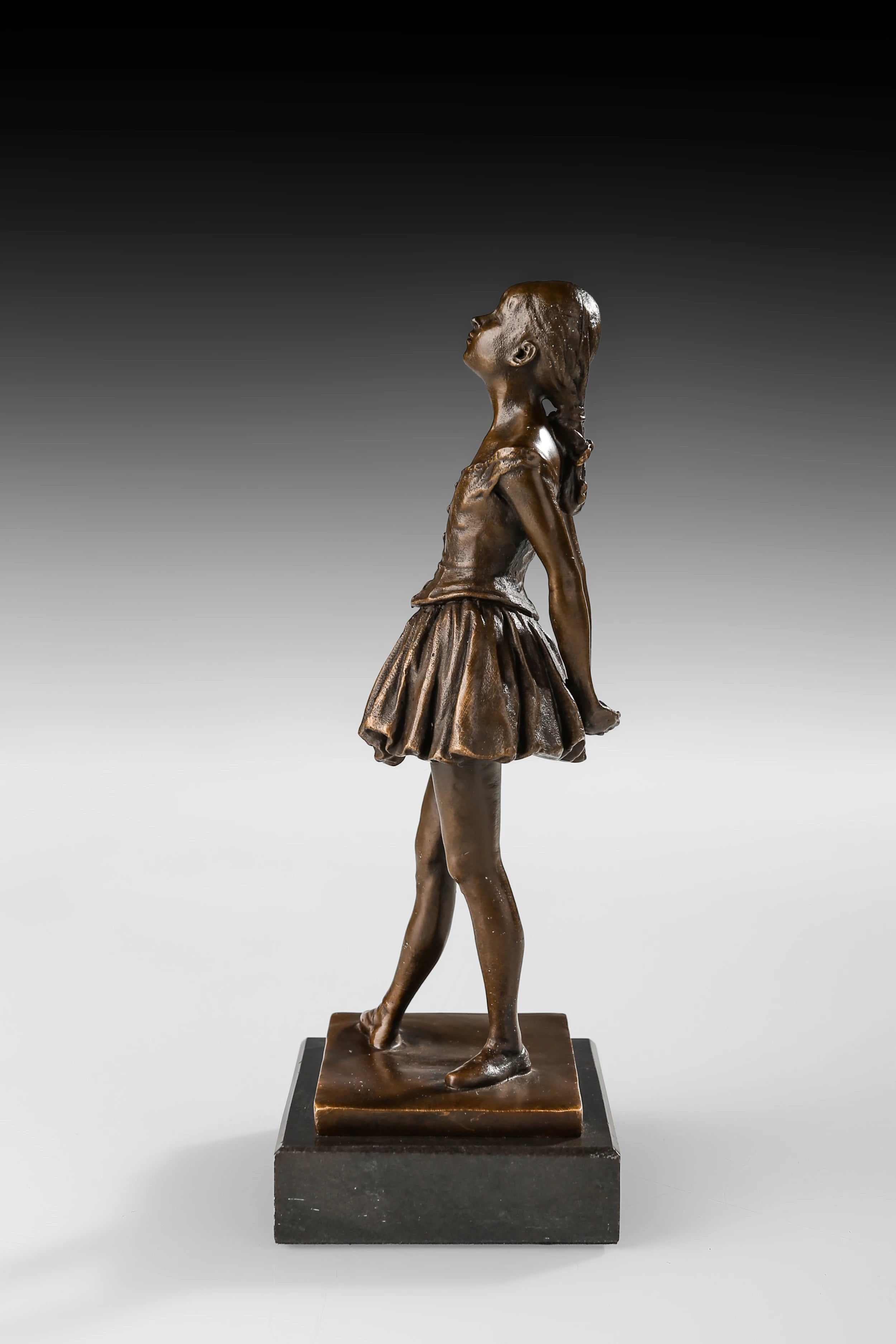Left side view of bronze schoolgirl sculpture with youthful standing pose and warm patina