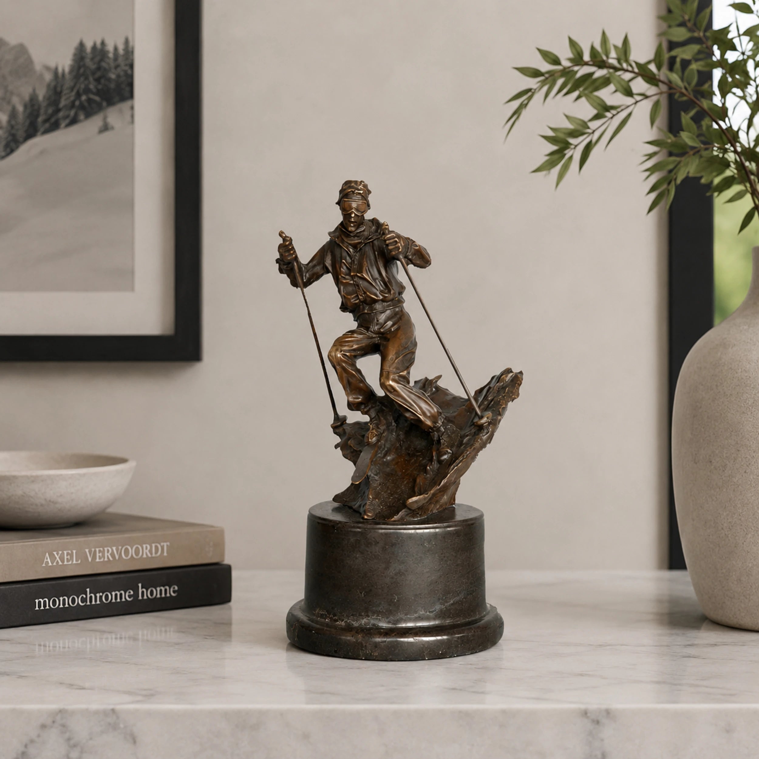 Bronze skier statue displayed as winter sports decor in a modern ski lodge interior.