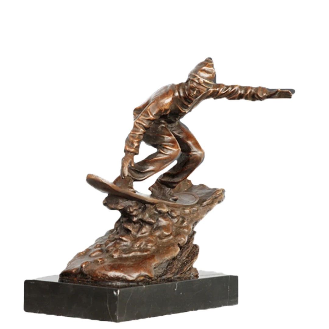 Handcrafted bronze snowboarder sculpture in a dynamic action pose on a marble base