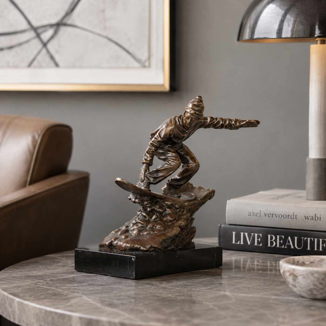 Bronze snowboarder statue displayed as modern winter sports decor in a ski lodge interior