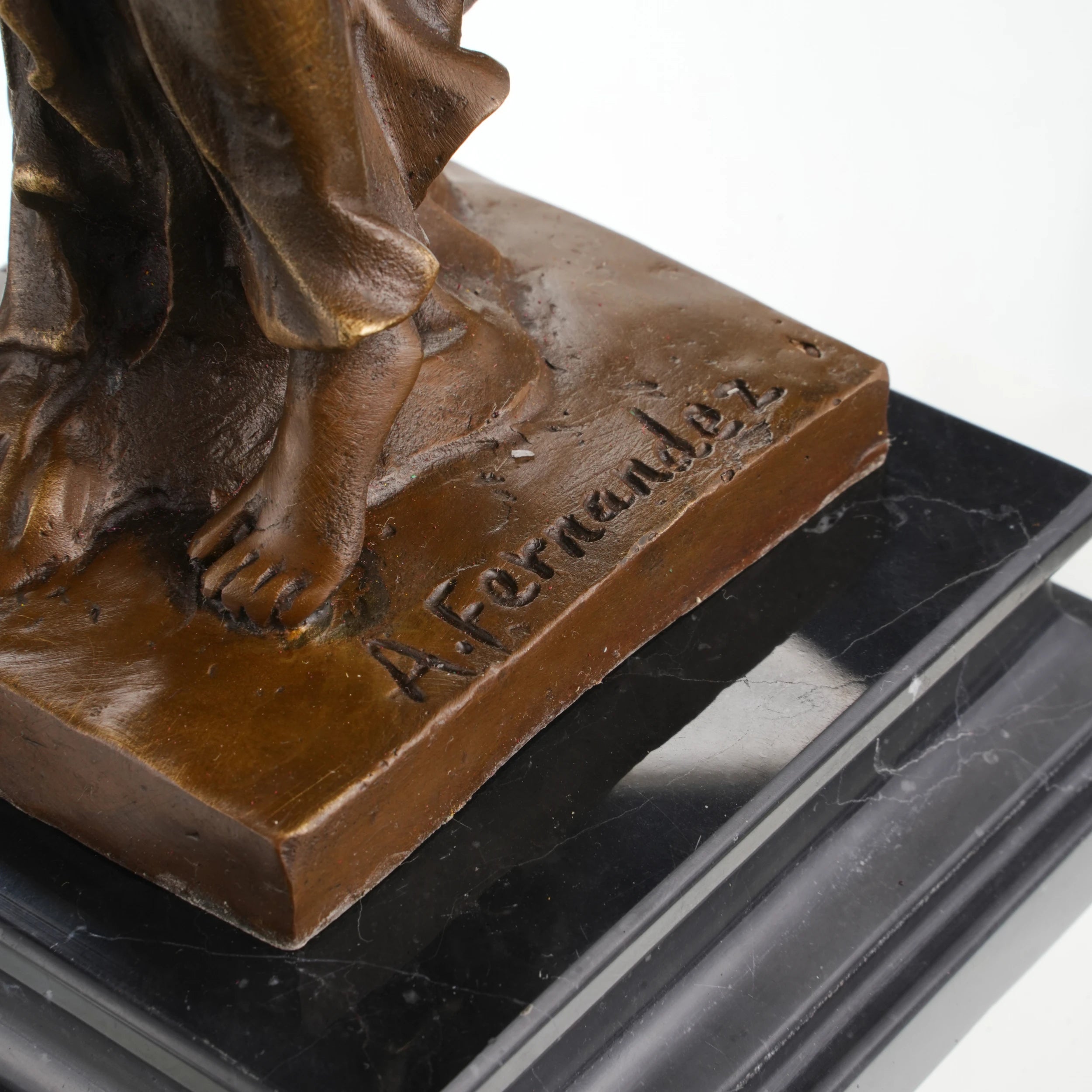 Bronze statue on tiered marble base