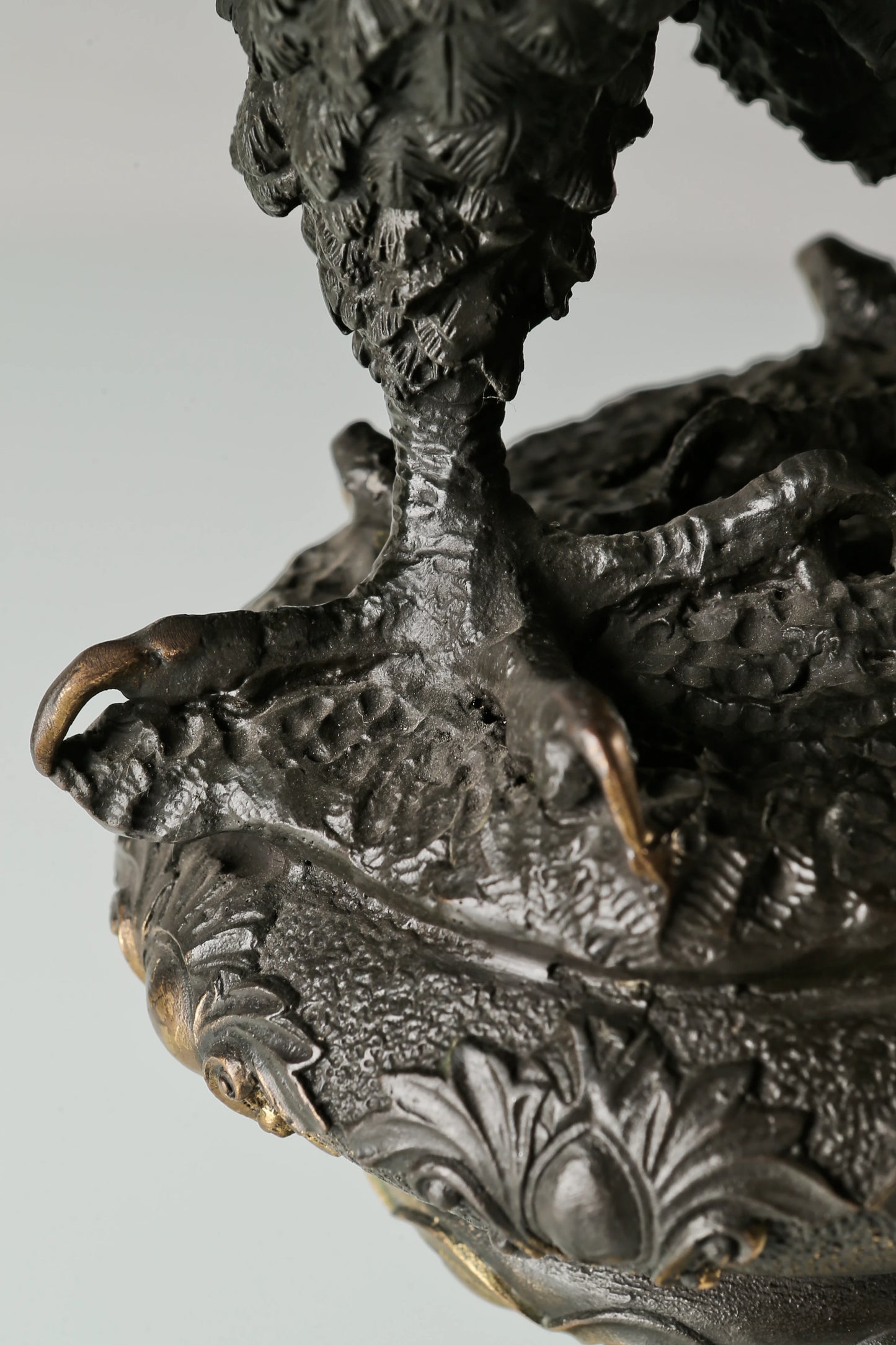 Bronze eagle statue with wings partially spread and decorative base. Classical wildlife sculpture for home decor, office, or collectors.