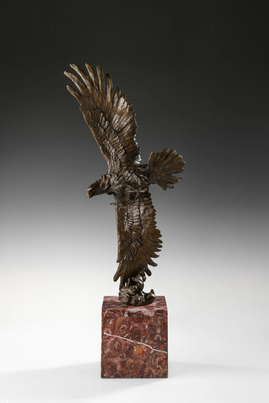 Bronze eagle sculpture over ocean waves with detailed feathers and marble base. Unique wildlife statue for home decor and collectors.