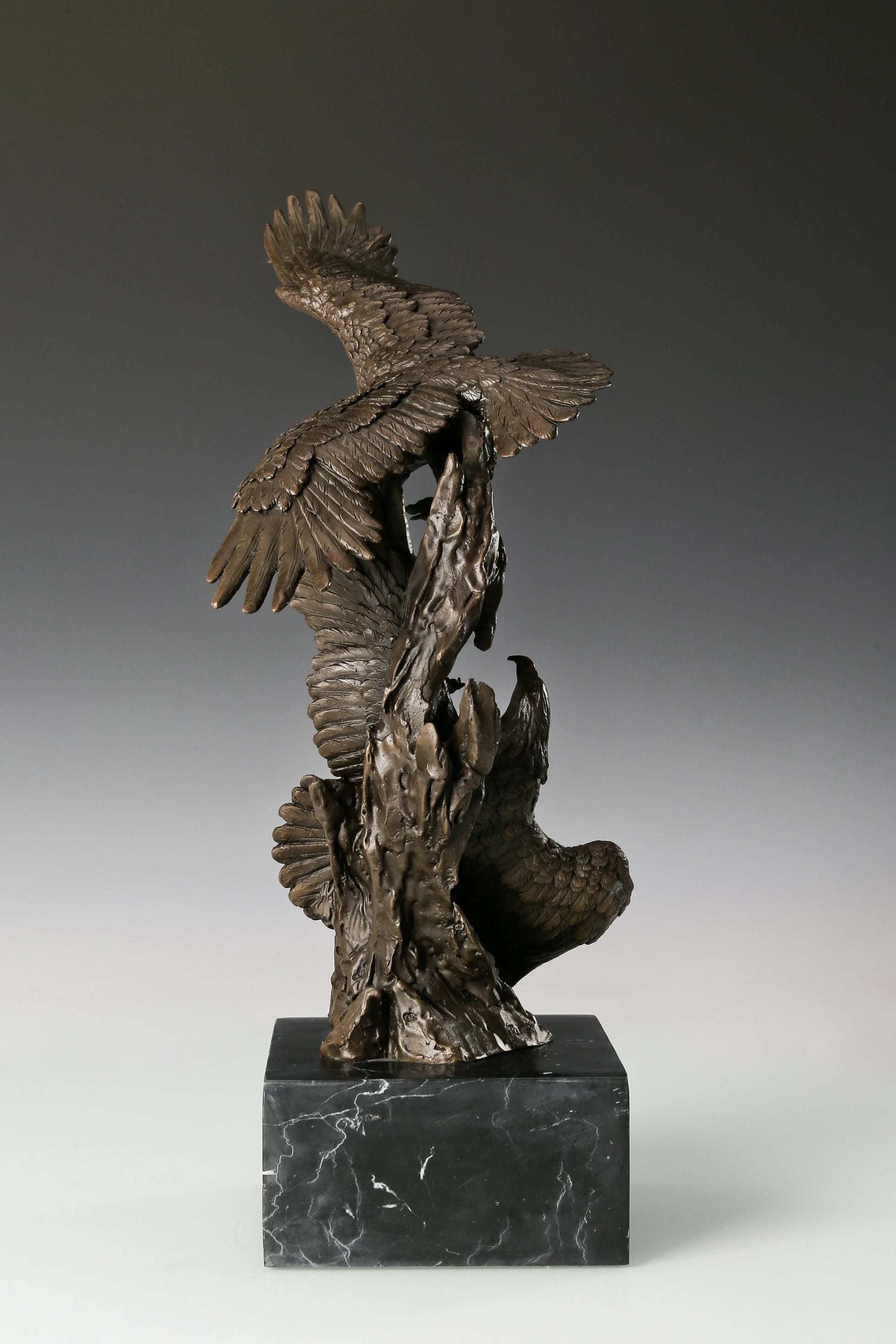 Own this powerful Solid Bronze Eagle Statue featuring two eagles in dynamic interaction. Set on a Black Marble Base, this Wildlife Bronze Art is a perfect Power Symbol for Executive Office Decor. Hand-cast quality.