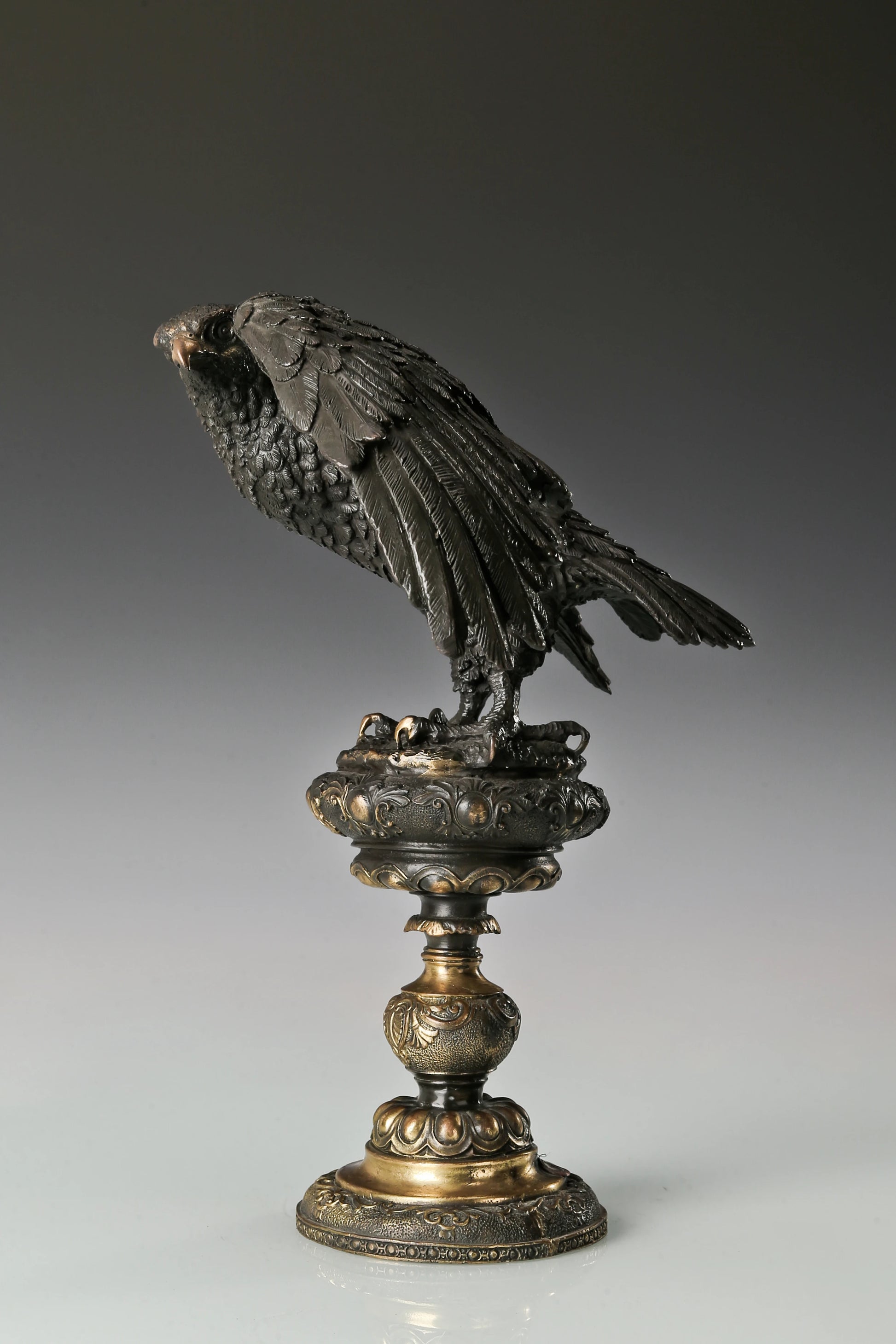 bronze eagle statue with ornate base