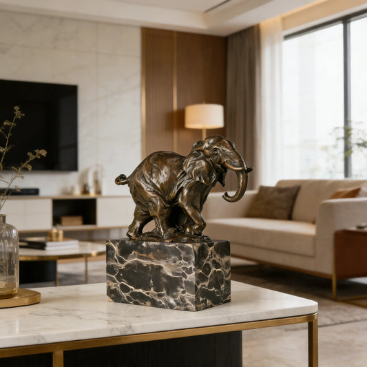 This dynamic bronze sculpture captures the powerful presence of an elephant in motion, masterfully crafted using the traditional lost-wax casting technique. The piece portrays the elephant striding forward with confident momentum, its trunk curling playfully upward while its tail flicks behind, creating a vivid sense of movement and vitality.