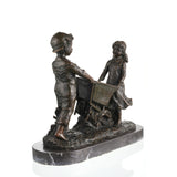 Nostalgic bronze sculpture of a boy and girl with a wheelbarrow on black marble base, heartwarming children playing art for home decor.