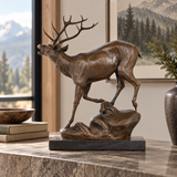Bugling bronze stag sculpture displayed as majestic wildlife decor in a refined lodge or office interior